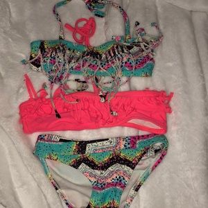 two bikini tops and one pair of bottoms